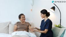 A nurse attending to a patient at home